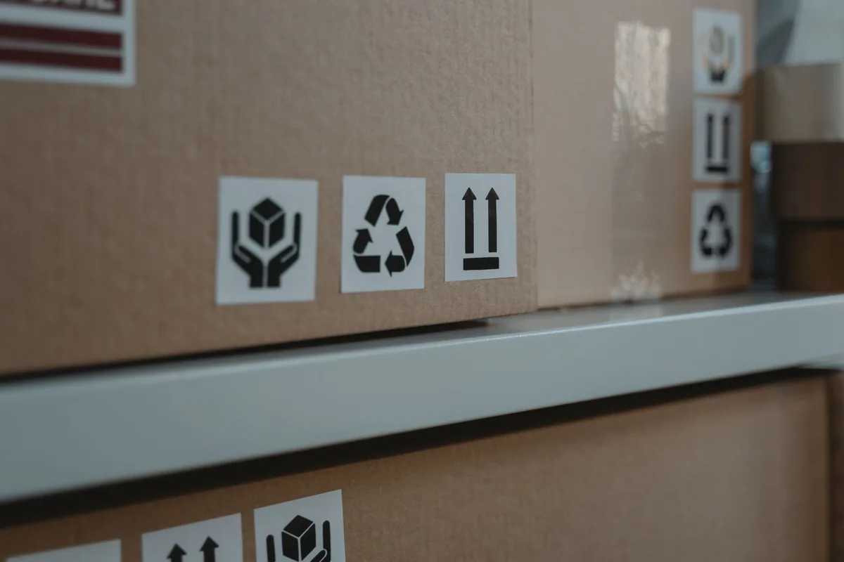 Close-up of handling symbols printed on cardboard shipping boxes.